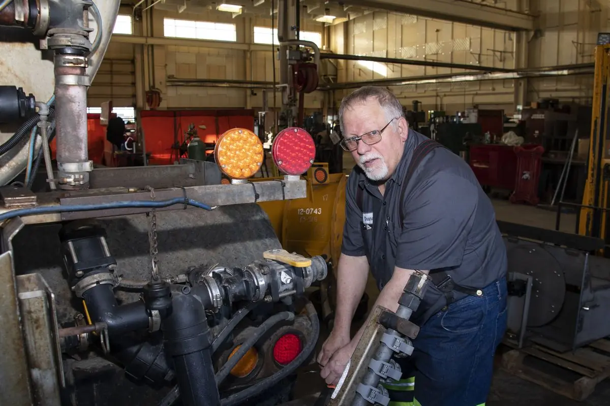 A shop mechanic works on snow removal equipment in a maintenance garage in La Grande, Oregon.